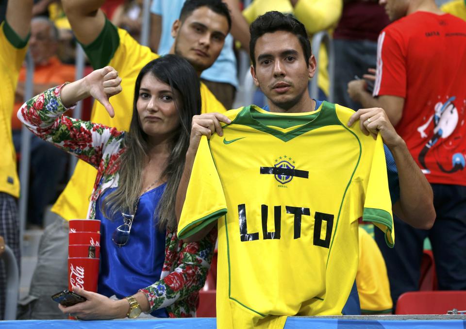 Fans hold up a Brazil jersey during the 2014 World Cup third-place playoff between Brazil and the Netherlands at the Brasilia national stadium