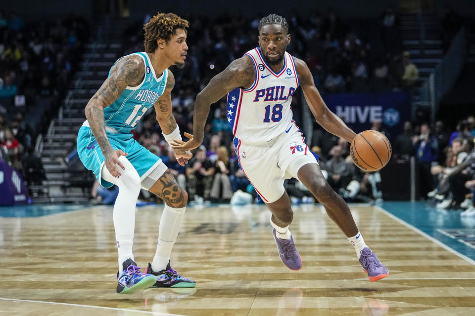 Philadelphia 76ers guard Shake Milton (18) drives around Charlotte Hornets guard Kelly Oubre Jr. (12) during the second half of an NBA basketball game Wednesday, Nov. 23, 2022, in Charlotte, N.C. (AP Photo/Rusty Jones)