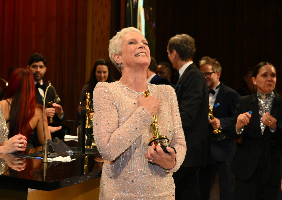 US actress Jamie Lee Curtis celebrates after winning the Oscar for Best Actress in a Supporting Role for 