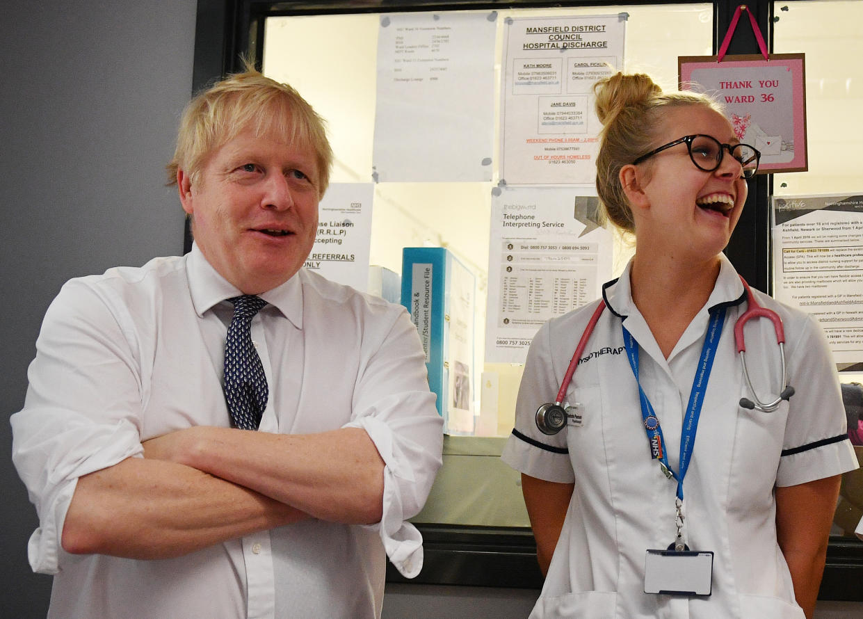 MANSFIELD, ENGLAND - NOVEMBER 08: Prime Minister Boris Johnson talks with a physiotherapist as he meets nursing staff during a general election campaign visit to King's Mill NHS Hospital in Mansfield on November 8, 2019 in Nottinghamshire, United Kingdom. (Photo by Daniel Leal-Olivas - WPA Pool/Getty Images)