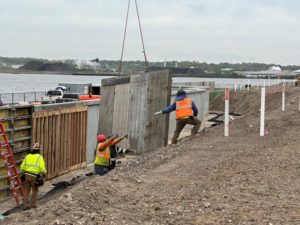 Workers build a concrete wall to serve as a platform for the buildings that will overlook the promenade and waterfront at Riverton, the $2.5 billion mixed-use community on the former National Lead site in Sayreville.