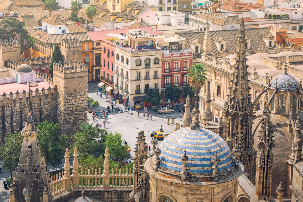A view of Seville with the spires of the Cathedral in the foreground (Getty Images)