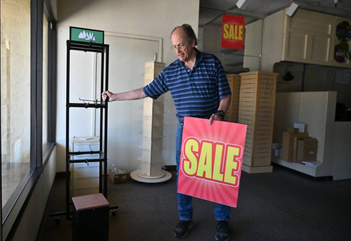 Tom Pearce, owner of Margie’s Hallmark Shop, clears out the store his parents opened 37 years ago near Clovis Avenue and Kings Canyon Road Friday in Fresno. After decades of service, Pearce has closed the shop.