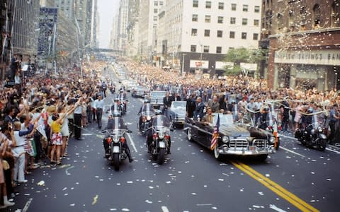 Aldrin, Collins and Armstrong wave to the crowds from an open-top car during the New York parade - Credit: GETTY IMAGES