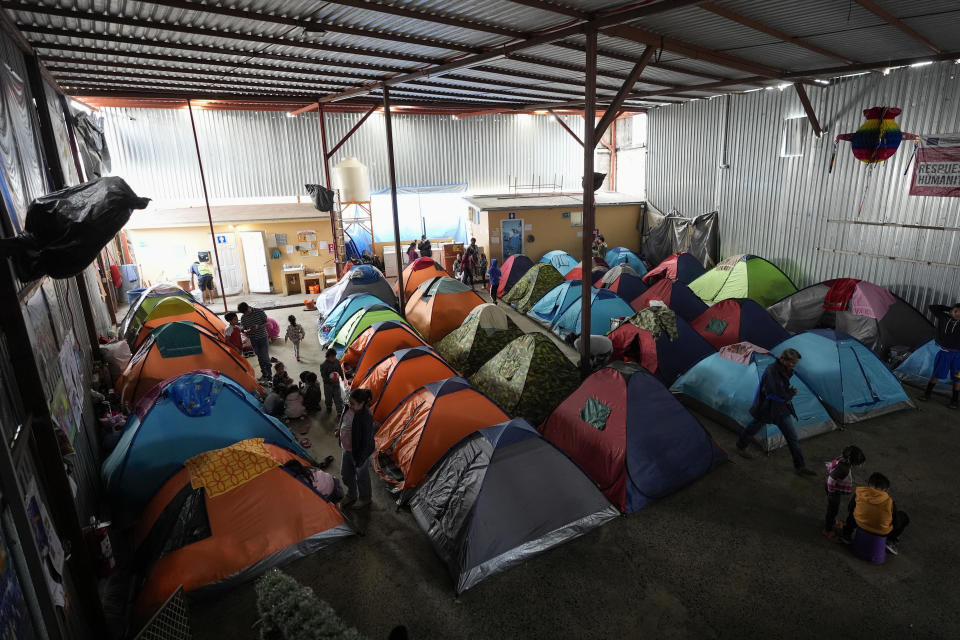Asylum seekers wait for appointments through the CBP One app to apply for asylum in the United States in a shelter for migrants, Saturday, Feb. 3, 2024, in Tijuana, Mexico. (AP Photo/Gregory Bull)