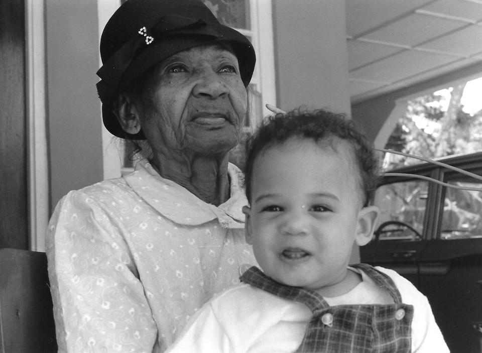 In this undated photo provided by the Kamala Harris campaign in April 2019, Iris Finegan holds her great granddaughter, Kamala Harris, in Jamaica. (Kamala Harris campaign via AP)