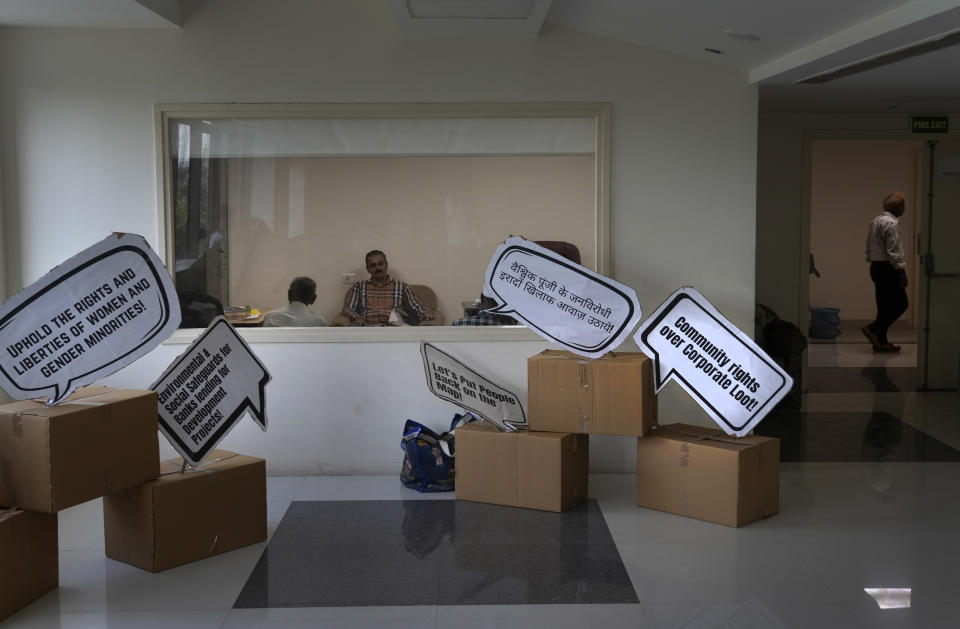 Guest speakers and organizers talk inside a room during a 'People's Summit on G20