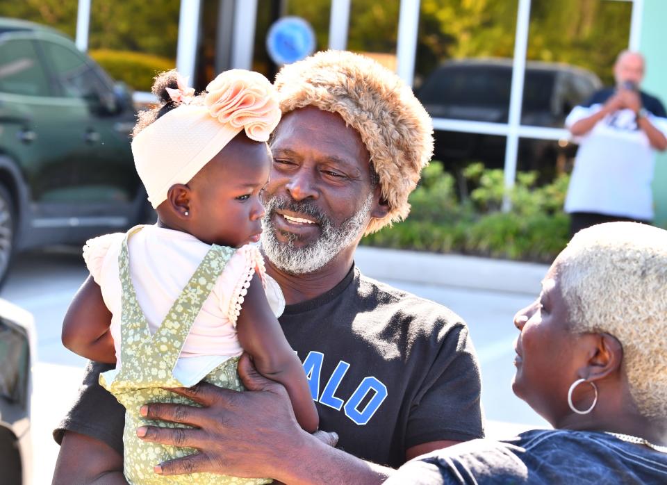 Crosley Green with his grand niece Blayke Jonathas just before turning himself in this April.