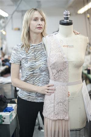 Fashion designer Rebecca Taylor stands with a mannequin wearing one of her creations in her studio in the Manhattan borough of New York, February 5, 2014. REUTERS/Keith Bedford