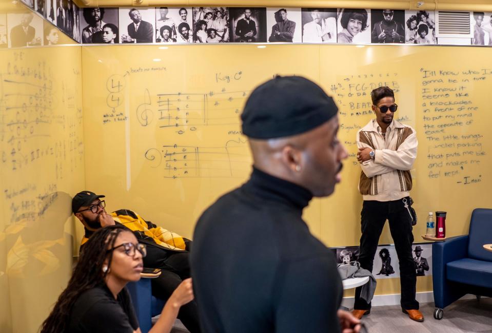 (Clockwise from left) Nora B. of Detroit, Jack Williams III of Detroit and Drey Skonie of Detroit, listen to Hitsville program director Tristan Andrews, center, in the Hitsville Next building at Detroit's Motown Museum on Thursday, March 9, 2023, ahead of the "Amplify" singing competition finale.