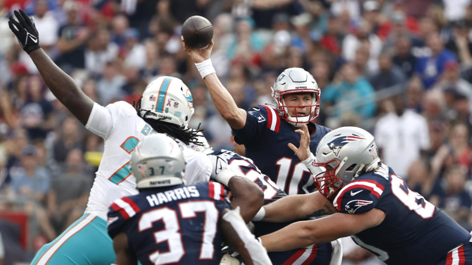 New England Patriots quarterback Mac Jones (10) passes under pressure during the first half of an NFL football game against the Miami Dolphins, Sunday, Sept. 12, 2021, in Foxborough, Mass. (AP Photo/Winslow Townson)