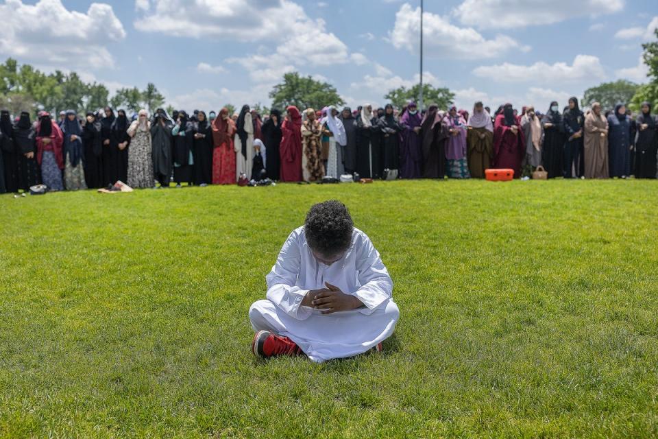 A young boy prays as women line up in prayer during the funeral for the people women killed in a car crash on Lake Street, at the Dar Al-Farooq Islamic Center in Bloomington, Minn., on Monday, June 19, 2023. (AP)