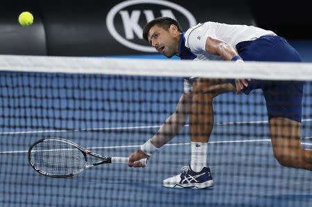 Tennis - Australian Open - Rod Laver Arena, Melbourne, Australia, January 22, 2018. Novak Djokovic of Serbia hits a shot against Chung Hyeon of South Korea. REUTERS/Issei Kato