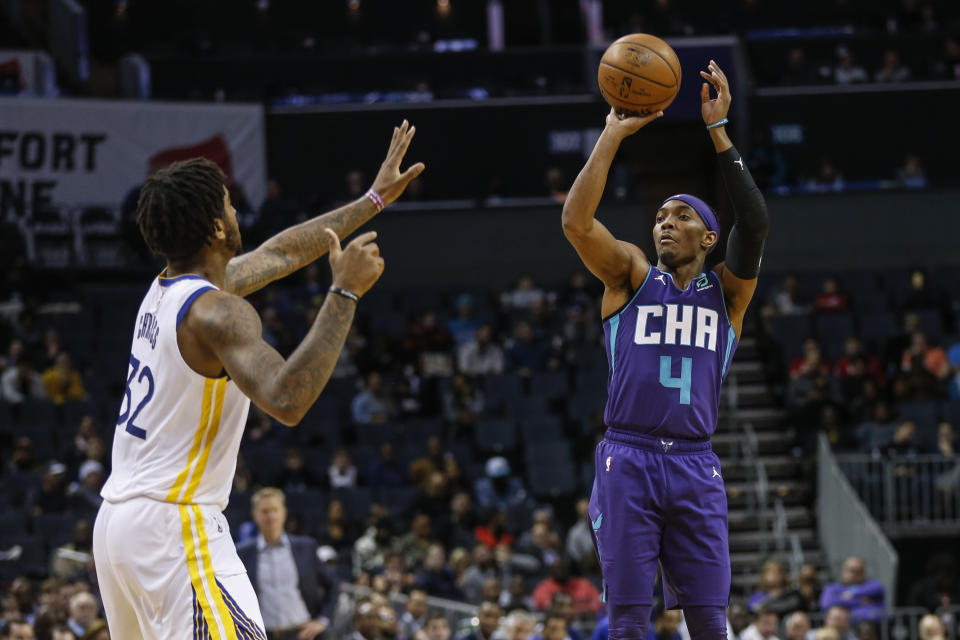 Charlotte Hornets guard Devonte' Graham (4) shoots over Golden State Warriors forward Marquese Chriss during the first half of an NBA basketball game in Charlotte, N.C., Wednesday, Dec. 4, 2019. (AP Photo/Nell Redmond)