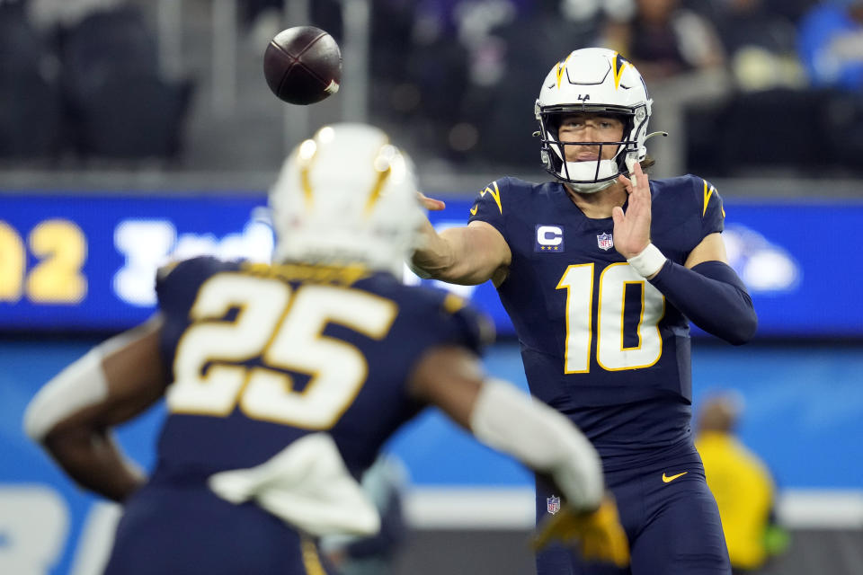 Los Angeles Chargers quarterback Justin Herbert (10) throws to running back Joshua Kelley (25) during the first half of an NFL football game Sunday, Nov. 26, 2023, in Inglewood, Calif. (AP Photo/Ashley Landis)