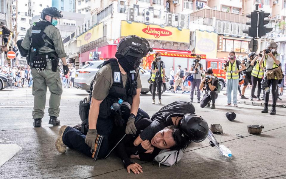 Police officers make an arrest during protests in the Causeway Bay neighbourhood of Hong Kong on July 1 after protests greeted China's imposition of its controversial national security law - LAM YIK FEI/ NYTNS / Redux / eyevine