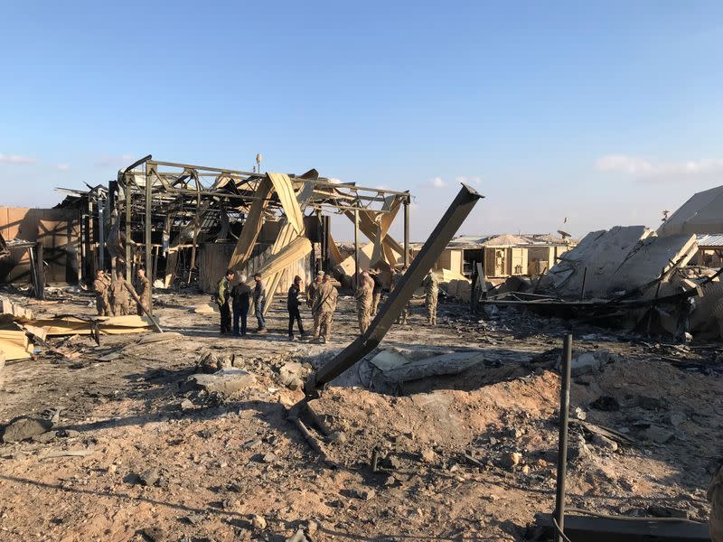 U.S. soldiers inspect the site where an Iranian missile hit at Ain al-Asad air base in Anbar province