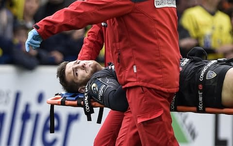 Lopez is stretchered off with a broken leg - Credit: AFP