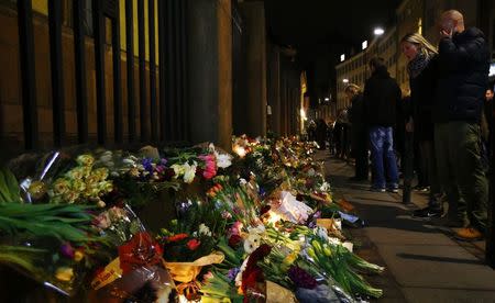 A man wipes his eyes at a memorial for the victims of the deadly attacks in front of the synagogue in Krystalgade in Copenhagen, February 15, 2015. REUTERS/Leonhard Foeger