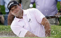 FILE - In this May 27, 2021, file photo, Patrick Reed plays a shot from a bunker on the fifth hole during the first round of the Charles Schwab Challenge golf tournament at the Colonial Country Club in Fort Worth, Texas. Bryson DeChambeau has tested positive for COVID-19 before leaving the United States for the Olympics and will miss the Tokyo Games. He’ll be replaced by Reed. (AP Photo/Ron Jenkins, File)