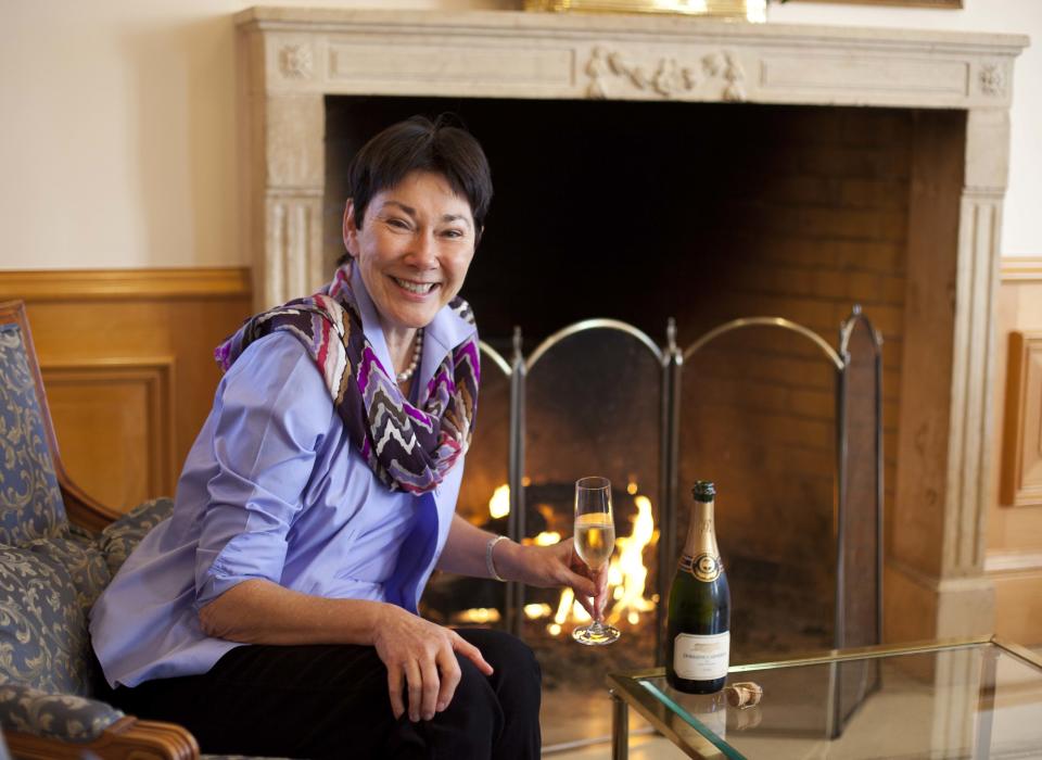 In this photo taken Wednesday, Nov. 14, 2012, CEO and winemaker Eileen Crane sits with a glass of Brut Cuvee sparkling wine at Domaine Carneros in Napa, Calif. Something new is bubbling up in the world of cocktails, using sparkling wine as a mixer. (AP Photo/Eric Risberg)