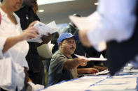 Job seekers fill out applications during the 11th annual Skid Row Career Fair at the Los Angeles Mission in Los Angeles, California, May 31, 2012. U.S. jobs growth probably snapped back in May from weather-related distortions that had slowed hiring, suggesting the economy was still expanding moderately despite strong headwinds from Europe. REUTERS/David McNew (UNITED STATES - Tags: BUSINESS EMPLOYMENT)