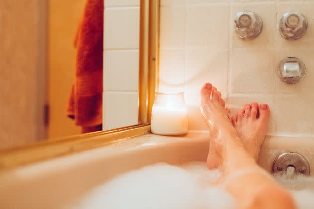 To help you de-stress, tap into what feels good in your body. Maybe it's a warm bath or a pair of silk PJs. (Photo: Jena Ardell via Getty Images)