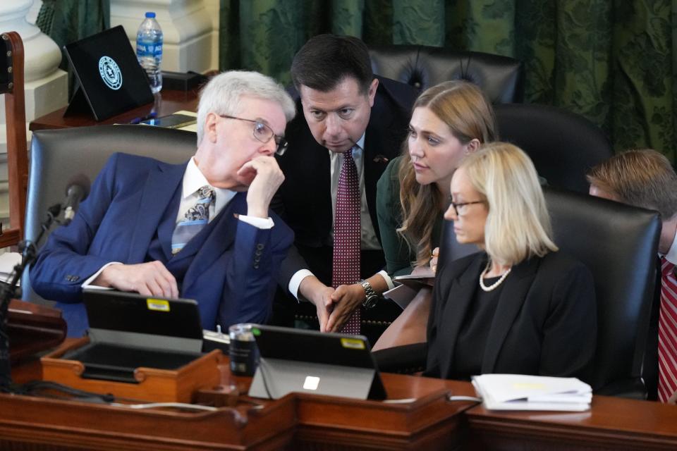 Lt. Gov. Dan Patrick, left, confers with colleagues during the trial.