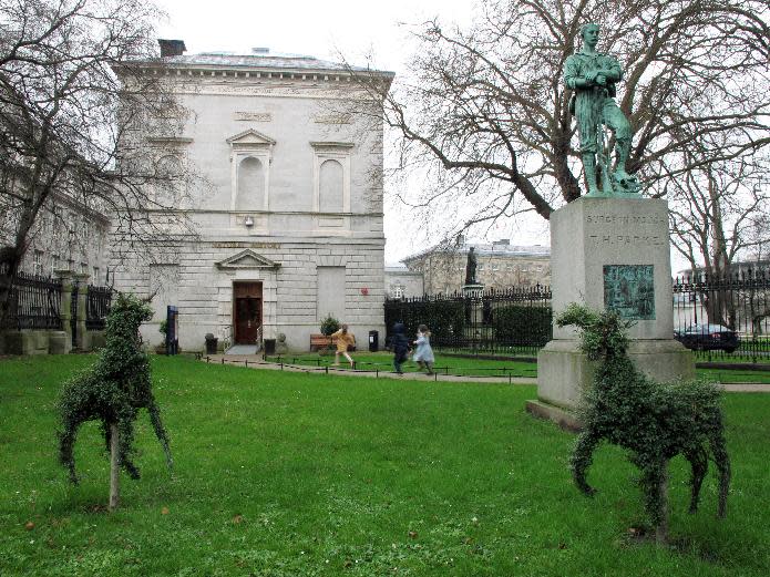 This Feb. 12, 2013 photo shows children running toward the entrance of the Natural History Museum of Ireland in Dublin. The museum, with its playful hedge animals, displays the flora and fauna of Ireland. It is one of several Dublin museums offering free admission year-round. (AP Photo/Shawn Pogatchnik)