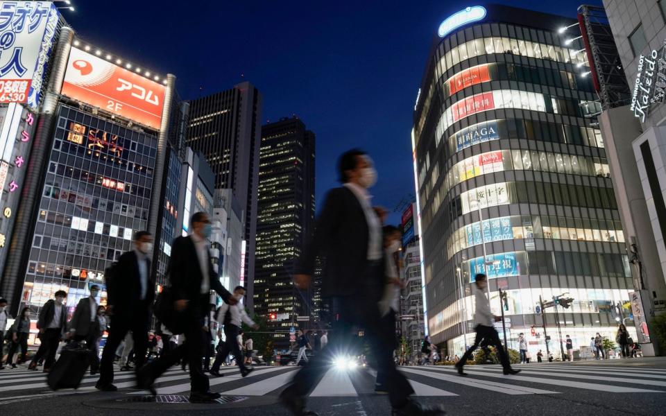 People wearing facemasks in Tokyo - Japan to end state of emergency in Tokyo as cases dwindle despite low testing and lack of strict lockdown - SHUTTERSTOCK