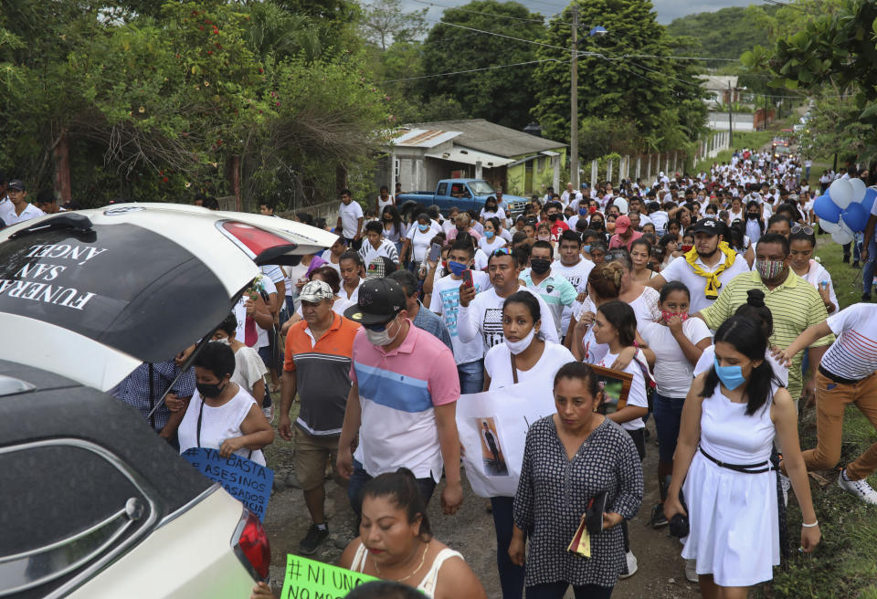 The hearse carrying the remains of Alexander Martinez is followed by a multitude of family and friends during his funeral in Acatlan de Perez Figueroa, Mexico, Thursday, June 11, 2020. Hundreds of residents of this town in southern Mexico bid farewell amid anger and tears to Alexander Martinez, a 16-year-old Mexican-American boy shot dead by local police. (AP Photo/Felix Marquez)
