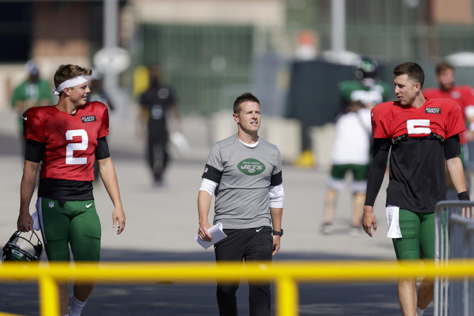 New York Jets quarterback Zach Wilson (2), offensive coordinator Mike LaFleur and quarterback Mike White (5) make their way to a joint NFL football training camp practice with the Green Bay Packers Wednesday, Aug. 18, 2021, in Green Bay, Wis. (AP Photo/Matt Ludtke)