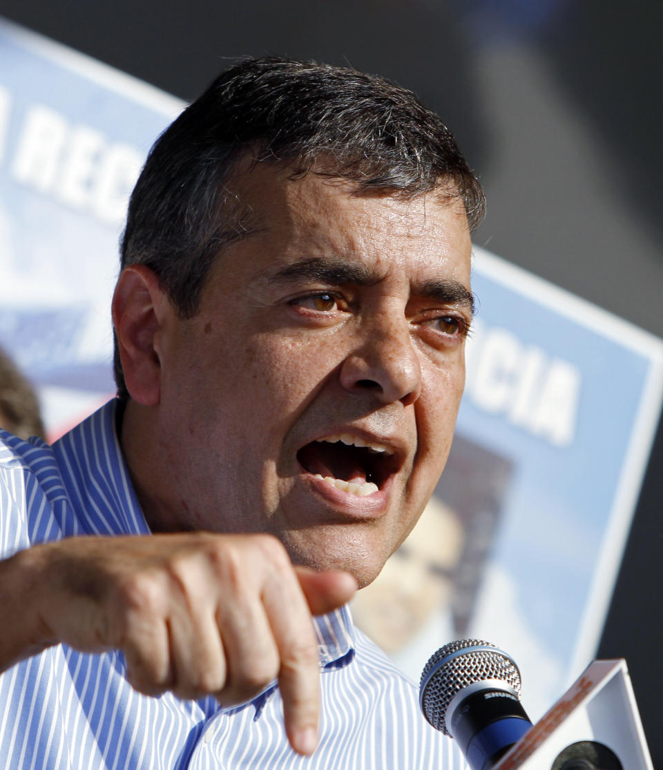 FILE - In this Feb. 24, 2011 file photo then Rep. David Rivera, R-Fla., talks during a freedom for Cuba march in Miami. Venezuela's socialist government tried to recruit former Congressman Pete Sessions to broker a meeting with the CEO of Exxon Mobil at the same time it was secretly paying a close former House colleague $50 million to keep U.S. sanctions at bay, The Associated Press has learned. (AP Photo/Alan Diaz)