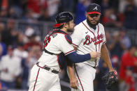 Atlanta Braves catcher Travis d'Arnaud (16) and relief pitcher Kenley Jansen celebrate the team's 4-2 victory in a baseball game against the New York Mets, Saturday, Oct. 1, 2022, in Atlanta. (AP Photo/Brett Davis)