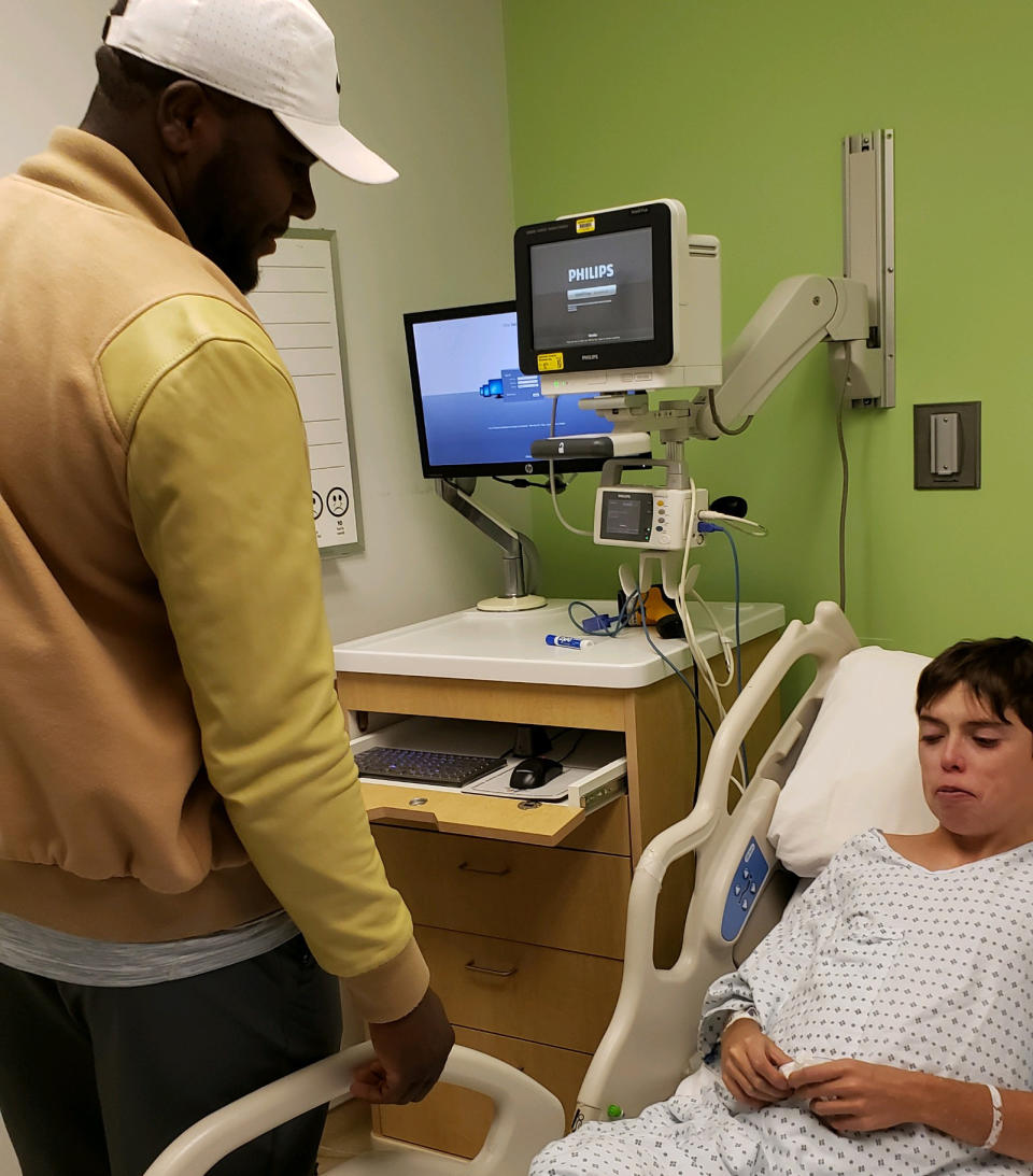 Former Ohio State quarterback Cardale Jones (L) visits Jared Foley in the hospital. The two have formed a bond since Jones' time at OSU. (Credit: Foley family)