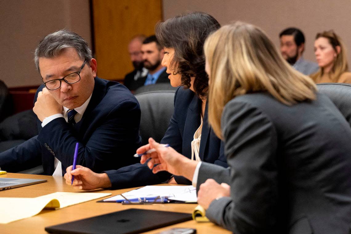 Washington state assistant attorneys general Kent Liu (left) and Patty Eakes (right) talk with state attorney general special assistant Lori Nicolavo (center) during a hearing on the possible rescheduling of the trial of the Tacoma police officers charged with killing Manny Ellis. Photographed on Friday, Dec. 2, 2022, at Pierce County Superior Court in Tacoma.