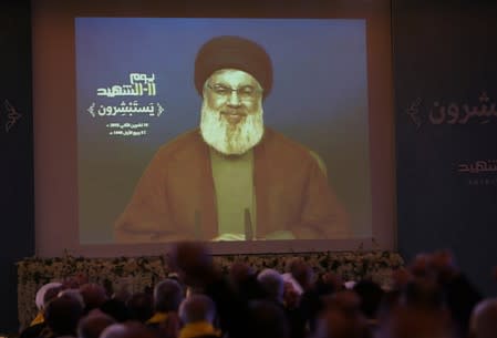 Lebanon's Hezbollah leader Sayyed Hassan Nasrallah addresses his supporters via a screen in Nabatiyeh