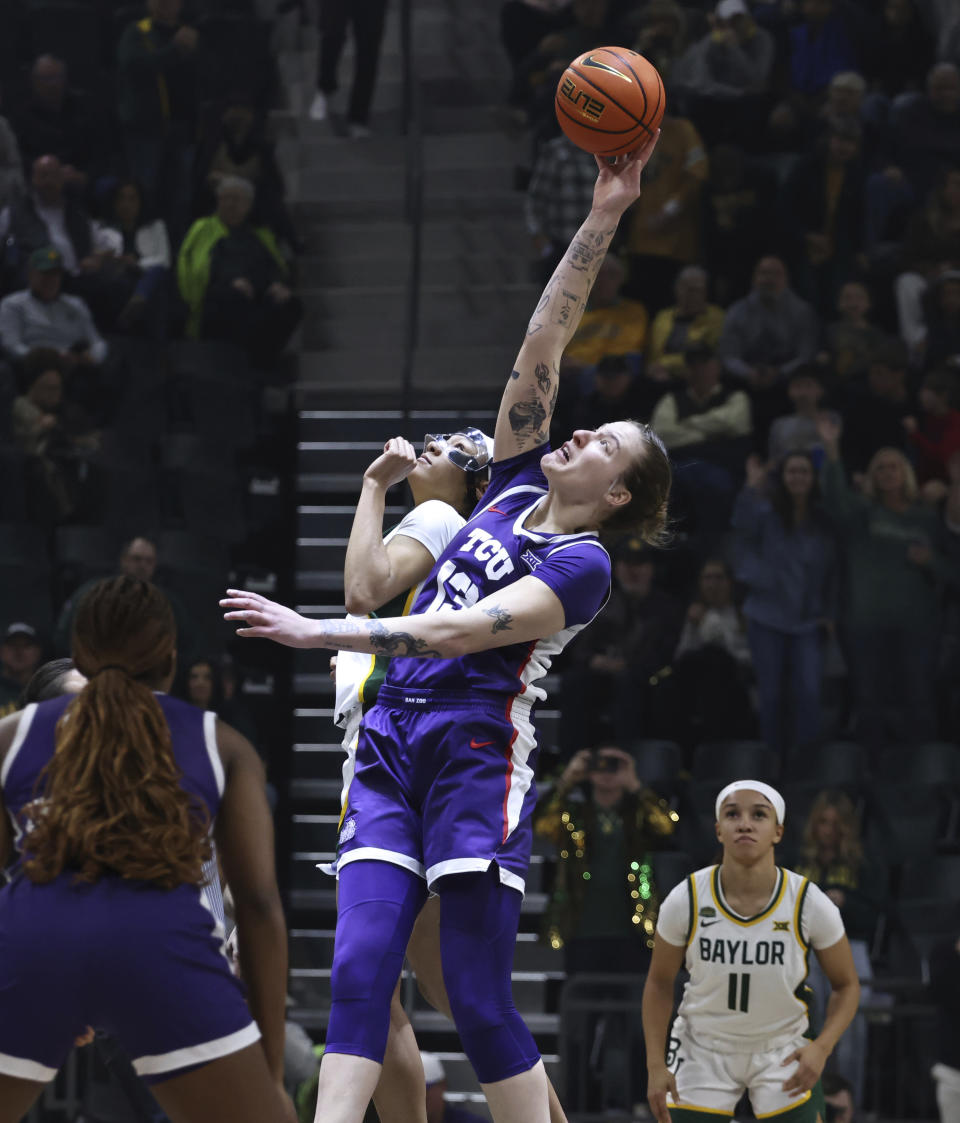 TCU forward Sedona Prince and Baylor guard Darianna Littlepage-Buggs reach for the opening tip in an NCAA college basketball game Wednesday, Jan. 3, 2024, in Waco, Texas. (Rod Aydelotte/Waco Tribune-Herald via AP)