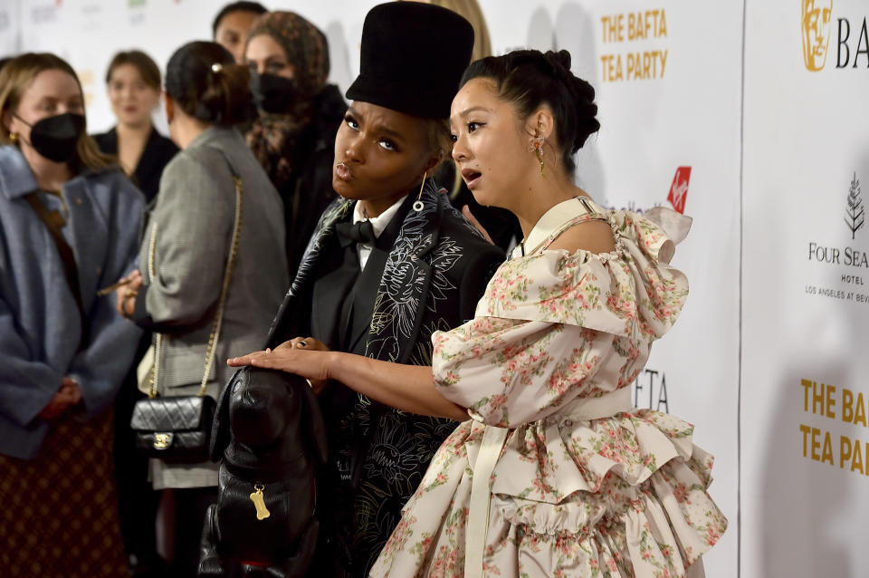 Actress Stephanie Hsu, right, pretends to pet the dog-shaped purse carried by Janelle Monae, left, at the 2023 BAFTA Tea Party, Saturday, Jan. 14, 2023, at the Four Seasons Hotel Los Angeles at Beverly Hills, in Los Angeles. (Photo by Jordan Strauss/Invision/AP)