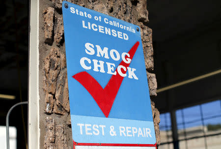 FILE PHOTO - A smog testing facility sign is shown marking a garage as a certified testing station for vehicles in Encinitas, California September 23, 2015. REUTERS/Mike Blake/File Photo