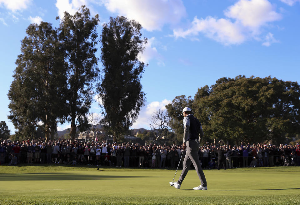 Tiger Woods reacts after making an eagle putt on the 11th hole as the gallery cheers on during the third round of the Genesis Open golf tournament at Riviera Country Club on Saturday, Feb. 16, 2019, in the Pacific Palisades area of Los Angeles. (AP Photo/Ryan Kang)