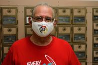 OJ Semans, the co-director of a Native American voter advocacy group, poses in the post office in Mission, South Dakota on Aug. 6, 2020. Semans shares a post office box with members of his extended family and says that a reliance in mail-in voting makes it difficult for Native Americans to cast their ballot. (AP Photo/Stephen Groves)