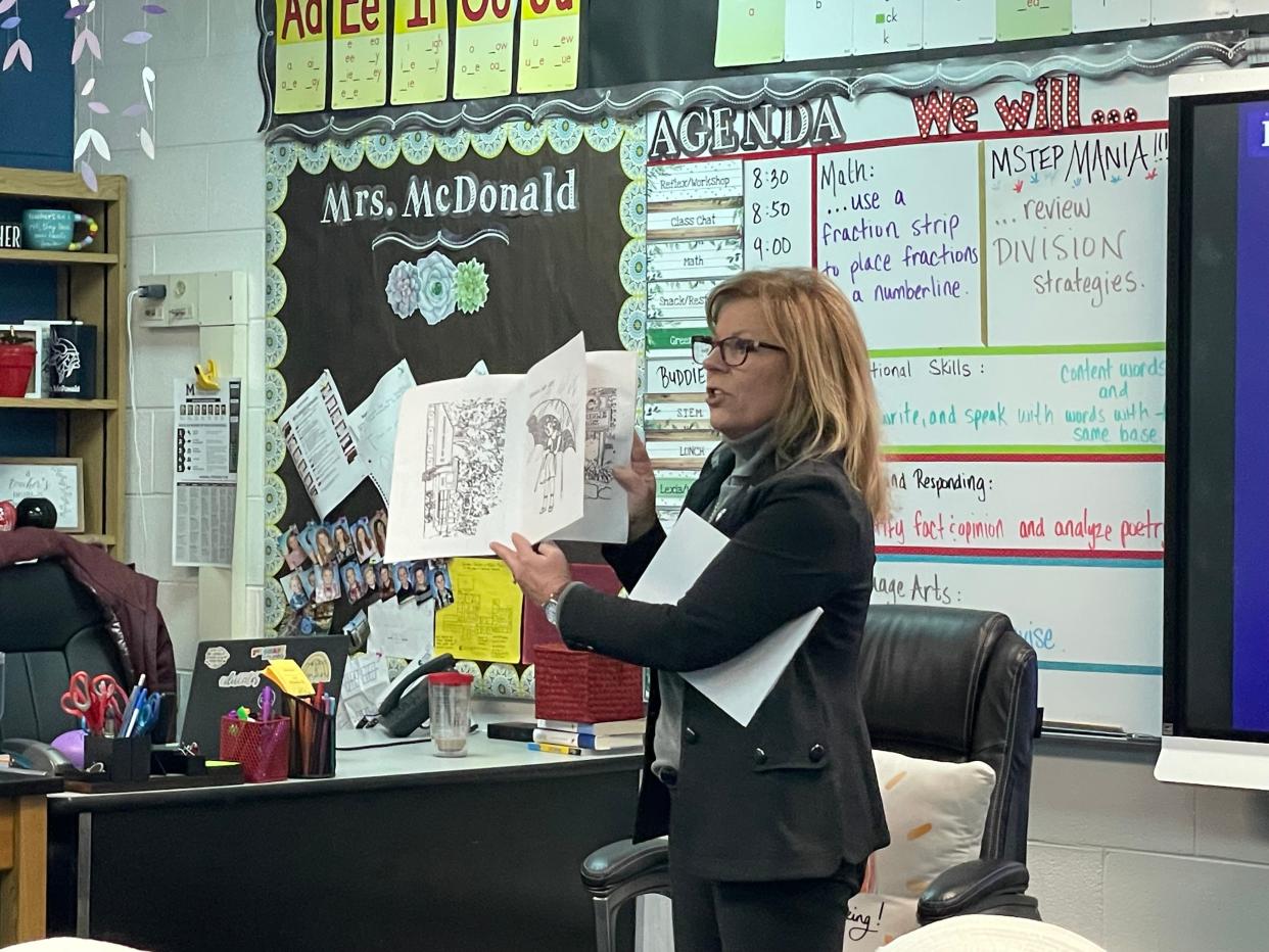 Marysville Mayor Kathy Hayman showing Morton Elementary School third graders pictures in the Marysville centennial coloring book on March 20, 2024.