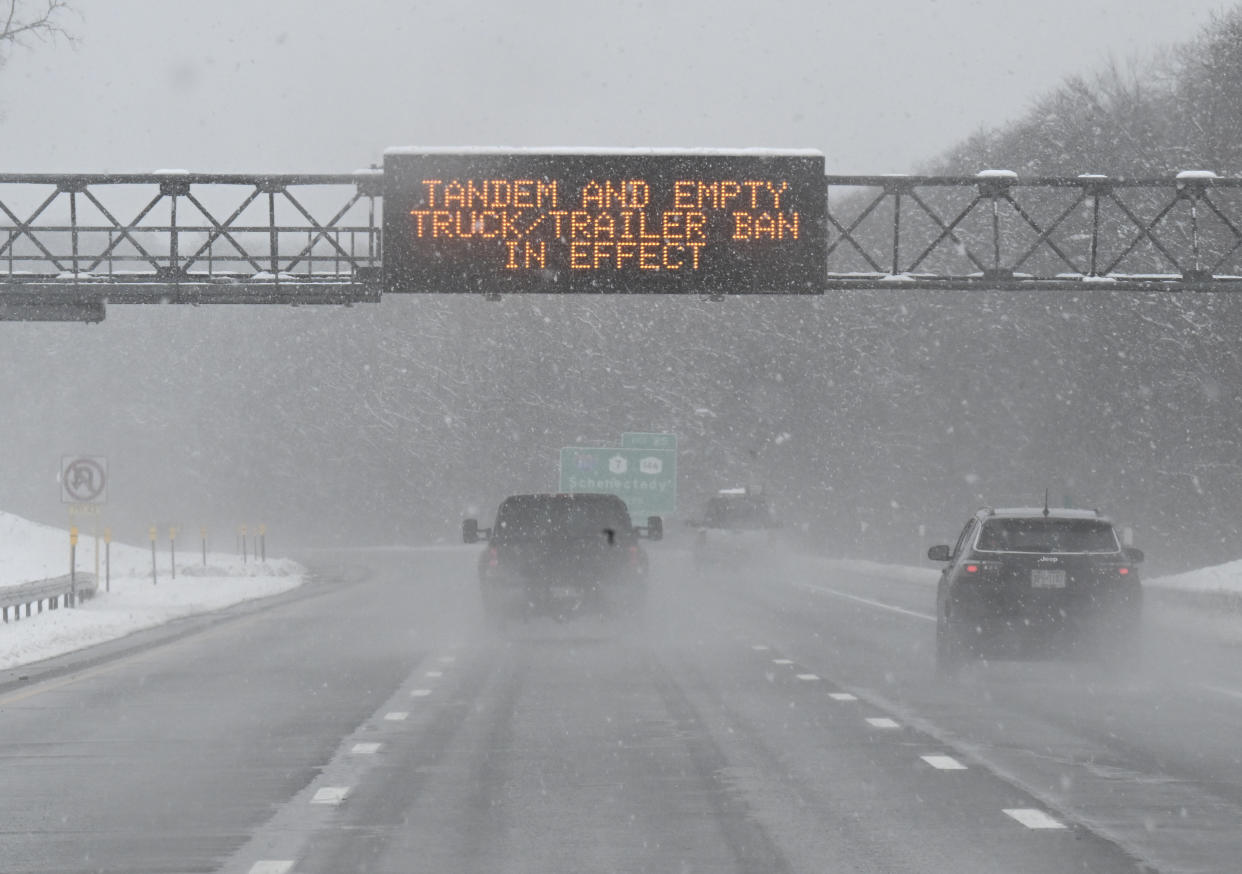 A roadway caution sign is seen on the New York Thruway as motorists commute during a winter snow storm Tuesday, March 14, 2023, in Albany, N.Y. (AP Photo/Hans Pennink)