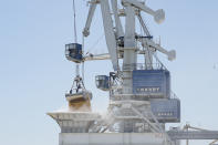 Cereals from Ukraine are unloaded from a barge in the Black Sea port of Constanta, Romania, Tuesday, June 21, 2022. While Romania has vocally embraced the ambitious goal of turning into a main hub for the export of agricultural products from Ukraine, economic experts and port operators in the country warn that it was much easier objective to set than to actually achieve. (AP Photo/Vadim Ghirda)