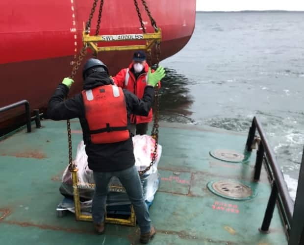 Community members wrapped the care package in shrink wrap and sent it to the ship with medical staff doing a routine check on the crew.