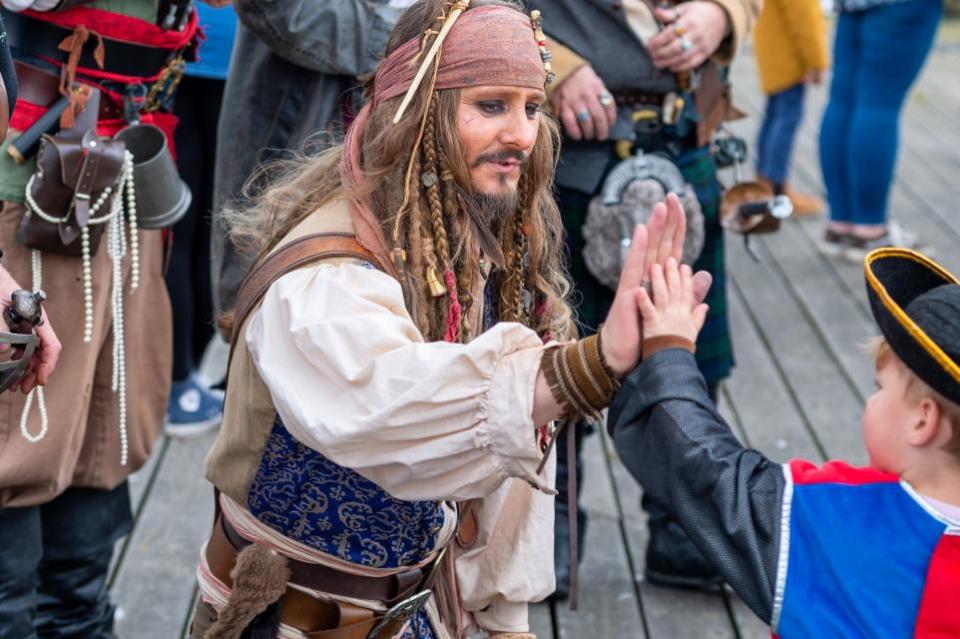 Echo: High five - a youngster meeting one of the pirates