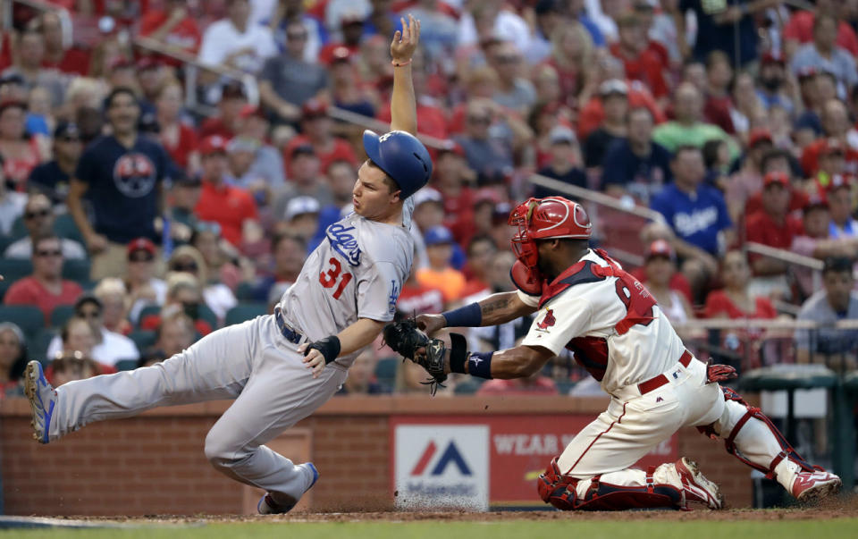 <p>Los Angeles Dodgers’ Joc Pederson, left, is tagged out at home by St. Louis Cardinals catcher Alberto Rosario during the sixth inning of a baseball game July 23, 2016, in St. Louis. (Photo: Jeff Roberson/AP)</p>