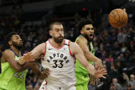 Toronto Raptors Marc Gasol (33) and Minnesota Timberwolves center Karl-Anthony Towns battle for the ball with Timberwolves forward Andrew Wiggins (22) defends in the second quarter of an NBA basketball game Saturday, Jan. 18, 2020, in Minneapolis. (AP Photo/Andy Clayton-King)