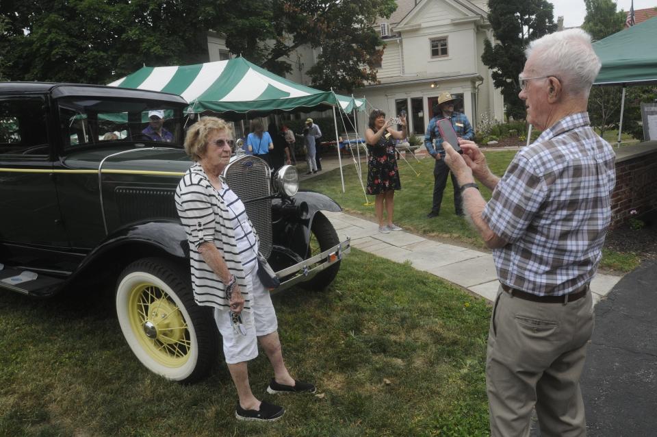 Dr. Al Garrett takes a photo of his wife Betty by an antique Ford on Sunday afternoon during the Ashland County Historical Society Ice Cream Social.